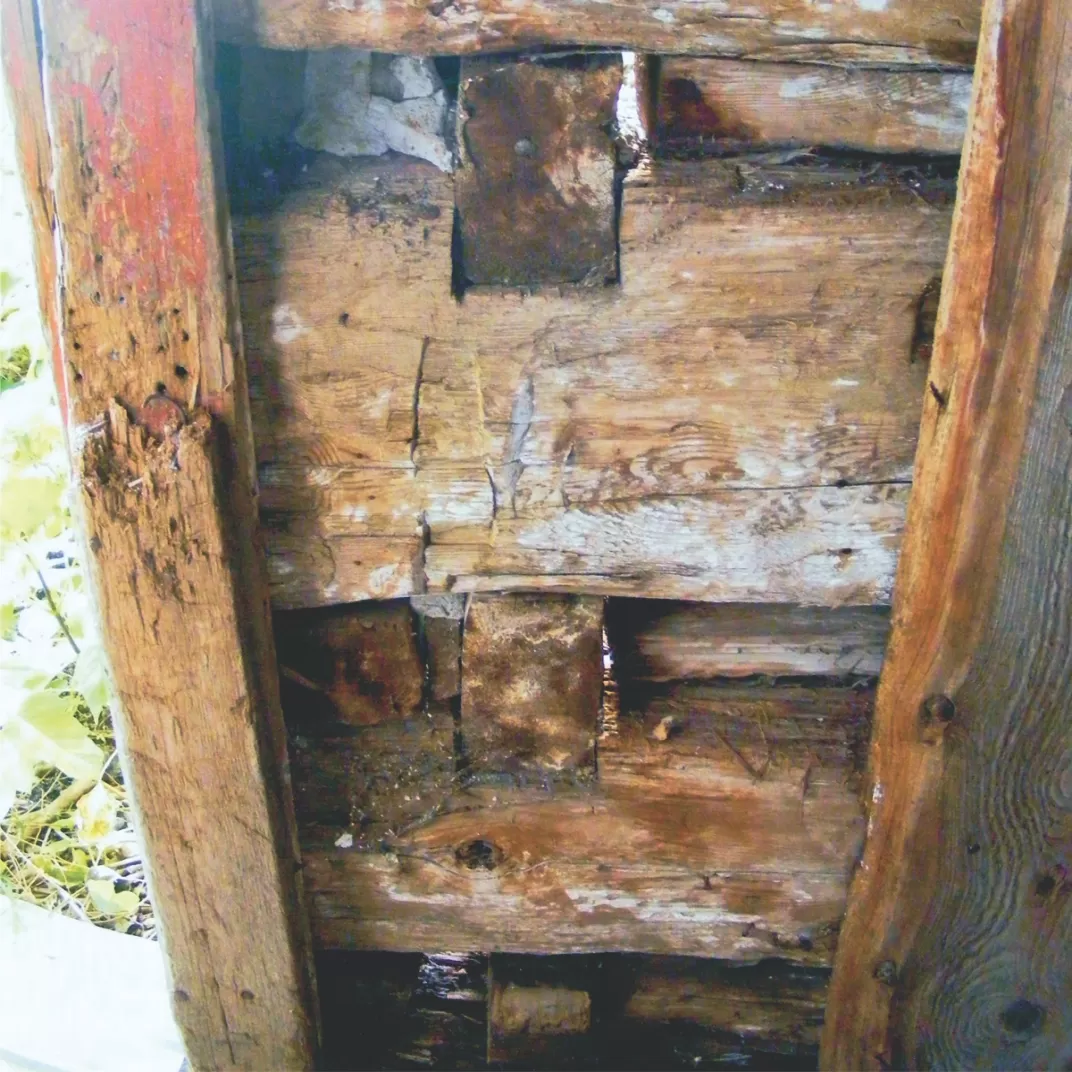 An old log house with careful dovetail cornering stands as a monument to the dream settler's skill and hope.