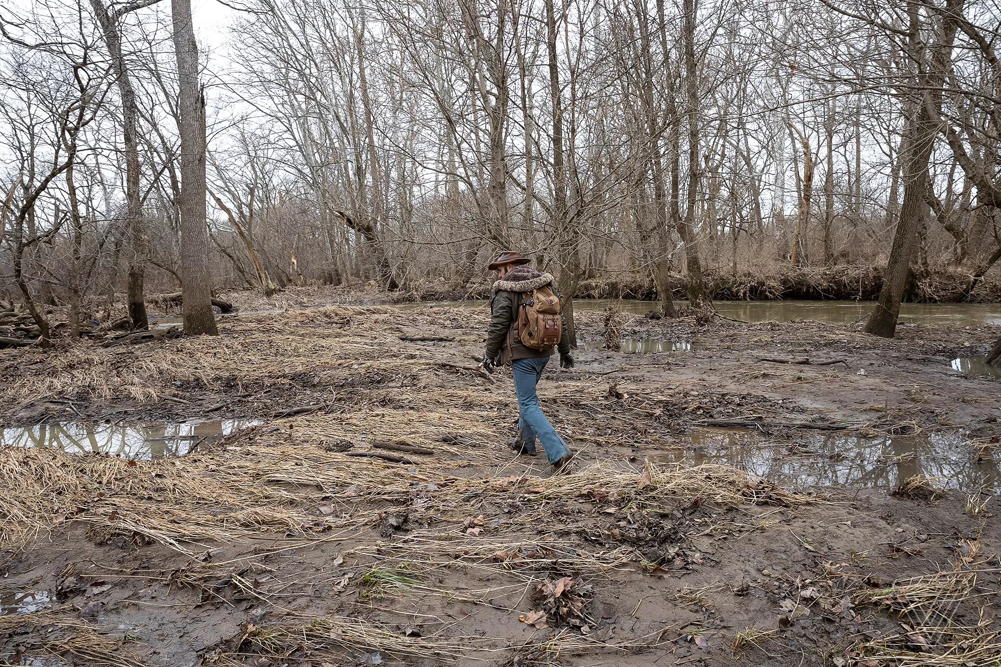 Coyote Peterson, star of Brave Wilderness, looks determined with a backdrop of trees, embodying the coyote brave wilderness spirit.
