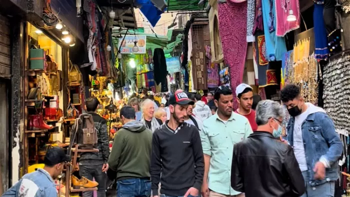 A bustling street scene in a Cairo bazaar, illustrating the vibrant settings explored in trip poems like 'If You Were in Cairo'