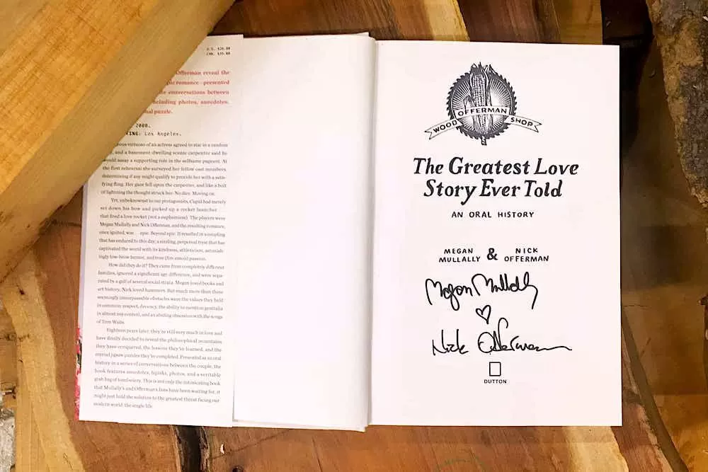 Interior page of the book shows autographs of Megan Mullally and Nick Offerman alongside the distinct Offerman Woodshop stamp, signifying the personal and crafted nature of their shared story.