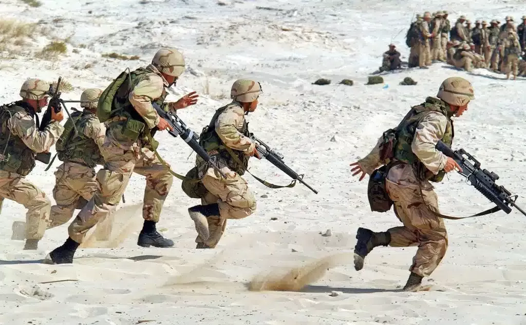 Silhouetted soldiers standing at sunset, representing remembrance and sacrifice for veterans who have died.